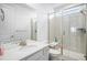 Bright bathroom with neutral tiled shower, glass door, and built-in bench at 2598 Knobbie Cir, Castle Rock, CO 80109