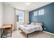Stylish bedroom features an accent wall, oversized window, and abundant natural light at 2598 Knobbie Cir, Castle Rock, CO 80109