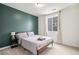 This bedroom features a large window, carpet, and gray color palette with a dark green accent wall at 2598 Knobbie Cir, Castle Rock, CO 80109