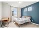 Stylish bedroom featuring an accent wall, modern decor, and large windows for natural light at 2598 Knobbie Cir, Castle Rock, CO 80109