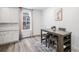 Cozy dining area features a gray wooden table with upholstered stools and a window with natural light at 2598 Knobbie Cir, Castle Rock, CO 80109