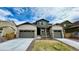 Charming two-story home featuring a manicured lawn and a two-car garage at 2598 Knobbie Cir, Castle Rock, CO 80109