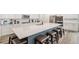 Spacious kitchen island with barstool seating, stainless appliances, and quartz countertops at 2598 Knobbie Cir, Castle Rock, CO 80109