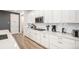Bright kitchen features white cabinets, stainless steel appliances, quartz countertops, and a gas cooktop at 2598 Knobbie Cir, Castle Rock, CO 80109