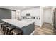 Kitchen featuring an island with seating, stainless appliances, and white subway backsplash at 2598 Knobbie Cir, Castle Rock, CO 80109