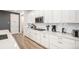 Kitchen featuring white cabinets, quartz counters, stainless appliances, and hardwood floors at 2598 Knobbie Cir, Castle Rock, CO 80109