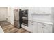 Bright kitchen featuring stainless steel appliances, white cabinets, and stylish countertops at 2598 Knobbie Cir, Castle Rock, CO 80109