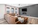Inviting living room with a cozy leather sectional, fireplace, and lots of natural light at 2598 Knobbie Cir, Castle Rock, CO 80109