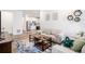 Cozy living room with modern furniture, rug, and view into a kitchen area at 2598 Knobbie Cir, Castle Rock, CO 80109