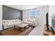 Spacious living room featuring a gray accent wall, neutral decor, and modern wood accents for a contemporary feel at 2598 Knobbie Cir, Castle Rock, CO 80109