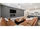 Open-concept living room and kitchen with a brown leather sectional and a cozy fireplace at 2598 Knobbie Cir, Castle Rock, CO 80109