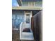 Close-up of the condo's front door with stairs and a weathered white railing at 264 S Newark Cir, Aurora, CO 80012