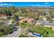Aerial view of a home, displaying a lush green lawn, mature trees, and neighborhood streets nearby at 3906 Hoyt Ct, Wheat Ridge, CO 80033