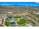 Aerial perspective of a community with sports facilities, fields, and green spaces at 3906 Hoyt Ct, Wheat Ridge, CO 80033