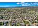 Aerial view of a residential community featuring homes, a lake, fields, and mountain views in the background at 3906 Hoyt Ct, Wheat Ridge, CO 80033