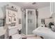 Modern bathroom featuring a stand-up shower, decorative tiles, and a pedestal sink at 3906 Hoyt Ct, Wheat Ridge, CO 80033
