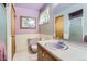Cozy bathroom featuring a pink sink, a tiled shower and traditional fixtures at 3906 Hoyt Ct, Wheat Ridge, CO 80033