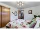 Cozy bedroom featuring a ceiling fan, closet and view to the staircase at 3906 Hoyt Ct, Wheat Ridge, CO 80033