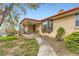 Charming brick home featuring a covered front porch and landscaped walkway at 3906 Hoyt Ct, Wheat Ridge, CO 80033