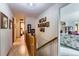 Bright hallway with hardwood floors leading to bedrooms and an open living area at 3906 Hoyt Ct, Wheat Ridge, CO 80033