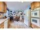 Bright kitchen with a dining area featuring an adjacent refrigerator and oven at 3906 Hoyt Ct, Wheat Ridge, CO 80033