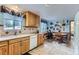 Cozy kitchen with light blue walls, light wood cabinets and a view to the outside at 3906 Hoyt Ct, Wheat Ridge, CO 80033