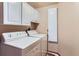 Cozy laundry room with white washer, dryer, and white cabinets at 3906 Hoyt Ct, Wheat Ridge, CO 80033