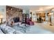 Open-concept living area with a striking stone fireplace and adjacent dining space at 3906 Hoyt Ct, Wheat Ridge, CO 80033