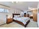 Well-lit bedroom featuring carpet, soft lighting and a closet with sliding doors at 3906 Hoyt Ct, Wheat Ridge, CO 80033