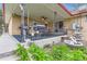 Covered patio featuring wrought iron decorations, outdoor kitchen, and small fountain at 3906 Hoyt Ct, Wheat Ridge, CO 80033