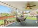 Covered patio featuring a metal table, seating, ceiling fan, grill and backyard view at 3906 Hoyt Ct, Wheat Ridge, CO 80033