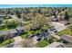 Street view of a home with a mature tree, well-kept lawn, and cars parked on the street at 3906 Hoyt Ct, Wheat Ridge, CO 80033