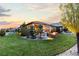 Spacious backyard featuring a fire pit, lush green grass, and landscaped areas at 10660 Winding Pine Pt, Highlands Ranch, CO 80126