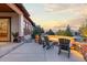 Cozy outdoor patio with a stone fire pit, comfortable seating, and scenic views at 10660 Winding Pine Pt, Highlands Ranch, CO 80126