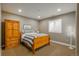 Comfortable bedroom with wood floors, wood bed frame, and a built-in wardrobe at 10660 Winding Pine Pt, Highlands Ranch, CO 80126