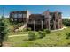 Stunning multi-level home with stone accents, large windows, and a landscaped yard at 10660 Winding Pine Pt, Highlands Ranch, CO 80126