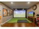 Fun golf simulator room features hardwood floors, recessed lighting, and movie posters at 10660 Winding Pine Pt, Highlands Ranch, CO 80126