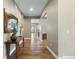 Neutral hallway with hardwood flooring, white trim, and decorative accents on wood table at 10660 Winding Pine Pt, Highlands Ranch, CO 80126