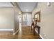 Neutral hallway with hardwood flooring, white trim, decorative accents, and a view to the front door at 10660 Winding Pine Pt, Highlands Ranch, CO 80126