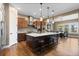 Spacious kitchen with wooden cabinets, stainless steel appliances, and an island with barstool seating at 10660 Winding Pine Pt, Highlands Ranch, CO 80126