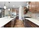 Modern kitchen featuring a large island, stainless steel appliances, and hardwood floors at 10660 Winding Pine Pt, Highlands Ranch, CO 80126