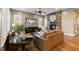Bright living room with hardwood floors, neutral walls, fireplace and built-in cabinetry at 10660 Winding Pine Pt, Highlands Ranch, CO 80126