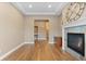 Open living room with fireplace, hardwood floors and neutral color palette at 10660 Winding Pine Pt, Highlands Ranch, CO 80126