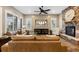 Living room showcasing a stone fireplace, hardwood floors, and comfortable seating at 10660 Winding Pine Pt, Highlands Ranch, CO 80126