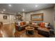 Comfortable living room with a large brown leather couch and a deer head decoration at 10660 Winding Pine Pt, Highlands Ranch, CO 80126