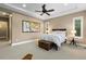 Serene bedroom featuring tray ceilings, neutral colors, and large windows for natural light at 10660 Winding Pine Pt, Highlands Ranch, CO 80126