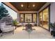 Covered patio with ceiling fan, dining set, and egg chairs offers a relaxing outdoor living space at 10660 Winding Pine Pt, Highlands Ranch, CO 80126