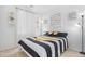 Bright bedroom with striking black and white bedding and contemporary artwork on the wall at 802 Eva Peak Dr, Erie, CO 80516