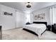 Serene bedroom featuring a plush bed, soft lighting, and elegant decor with a fan and carpet at 802 Eva Peak Dr, Erie, CO 80516
