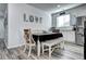 Dining area featuring a table with chairs and bench seating next to a kitchen with stainless steel appliances at 802 Eva Peak Dr, Erie, CO 80516